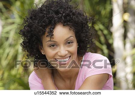 Stock Image - Portrait of young woman smiling. Fotosearch