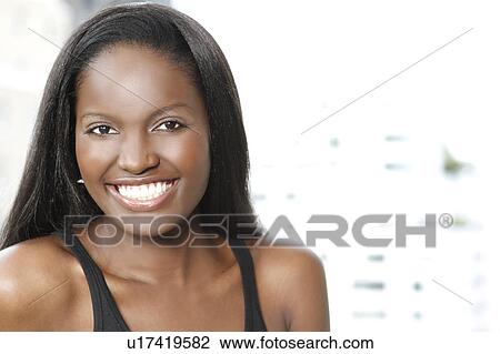 Stock Image - Portrait of young woman smiling. Fotosearch