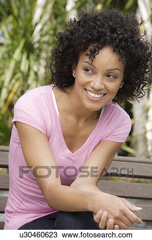 Stock Image - Portrait of young woman smiling. Fotosearch