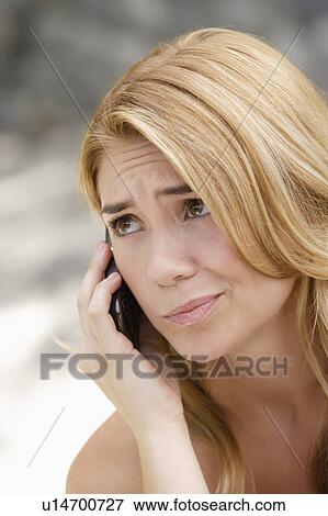 Portrait of young woman talking on phone View Large Photo Image Stock Photo - Portrait of young woman talking on phone. Fotosearch