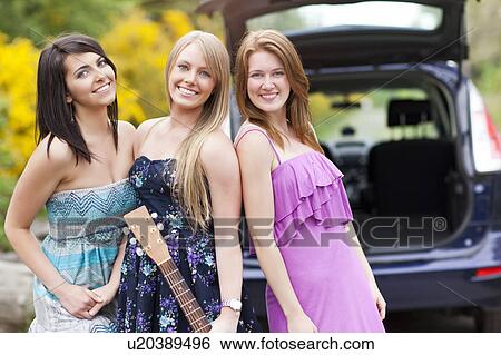 Portrait of young women with guitar by car View Large Photo Image Stock Photograph - Portrait of young women with guitar by car. Fotosearch