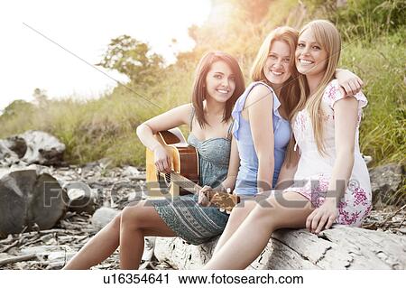 Portrait of young women with guitar on beach View Large Photo Image Stock Image - Portrait of young women with guitar on beach. Fotosearch