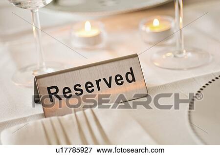 Stock Photo - Reservation tag on dining table. Fotosearch