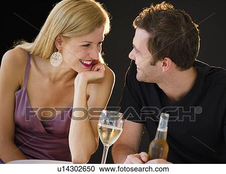 Stock Image - Romantic couple with drinks. Fotosearch