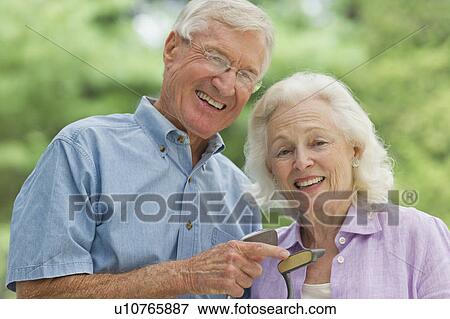 Stock Photo - Senior couple playing golf. Fotosearch