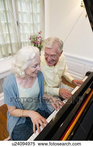 Stock Photography - Senior couple playing piano. Fotosearch