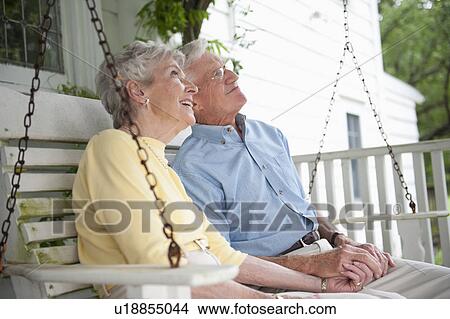 Senior couple sitting on porch swing View Large Photo Image Picture - Senior couple sitting on porch swing. Fotosearch
