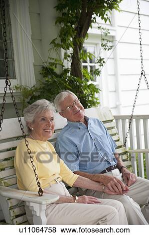Senior couple sitting on porch swing View Large Photo Image Stock Photo - Senior couple sitting on porch swing. Fotosearch