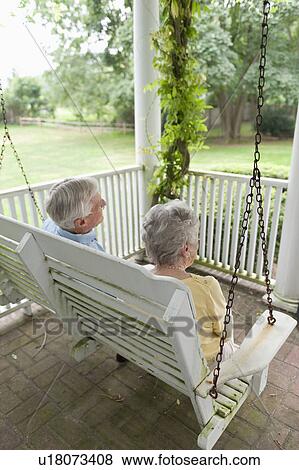 Senior couple sitting on porch swing View Large Photo Image Stock Photo - Senior couple sitting on porch swing. Fotosearch
