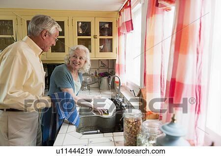 Stock Photo - Senior couple washing dishes. Fotosearch