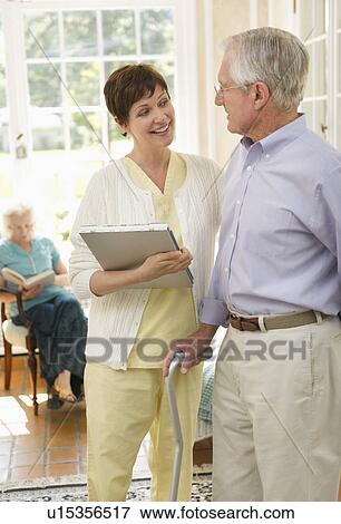 Senior man and nurse talking in nursing home View Large Photo Image Stock Photo - Senior man and nurse talking in nursing home. Fotosearch