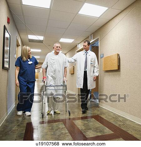 Stock Photo - Senior man in hospital walking with walker. Fotosearch