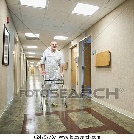 Stock Photo - Senior man in hospital walking with walker. Fotosearch
