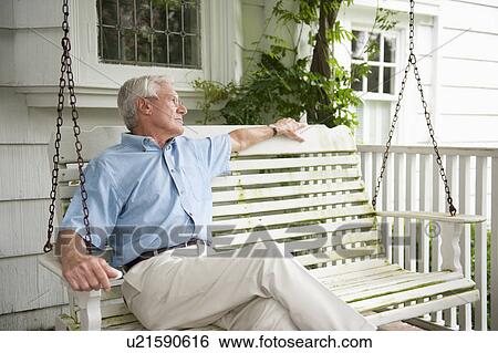 Senior man sitting on porch swing View Large Photo Image Stock Photograph - Senior man sitting on porch swing. Fotosearch