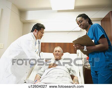 Senior patient with doctor and nurse View Large Photo Image Stock Photo - Senior patient with doctor and nurse. Fotosearch
