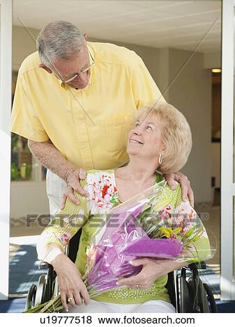 Stock Photo - Senior people going out from hospital. Fotosearch