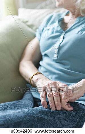 Senior woman sitting in chair, close-up of hands View Large Photo Image Stock Photograph - Senior woman sitting in chair, close-up of hands. Fotosearch