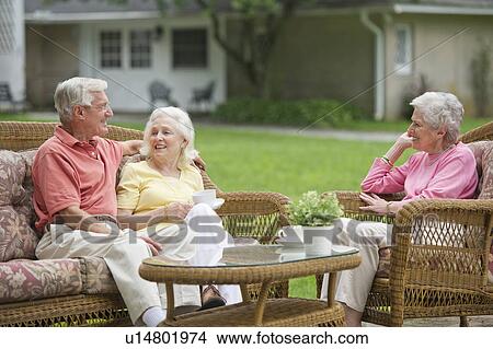 Seniors relaxing on outdoor sofa View Large Photo Image Picture - Seniors relaxing on outdoor sofa. Fotosearch