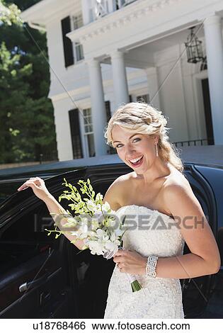 Smiling bride standing near limousine View Large Photo Image Stock Photograph - Smiling bride standing near limousine. Fotosearch