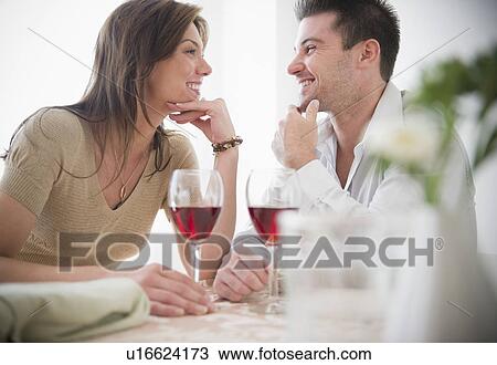 Stock Image - Smiling couple drinking wine. Fotosearch