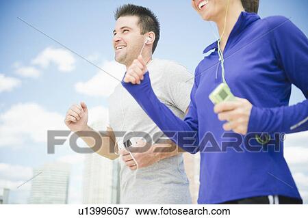 Smiling couple jogging together View Large Photo Image Stock Photo - Smiling couple jogging together. Fotosearch