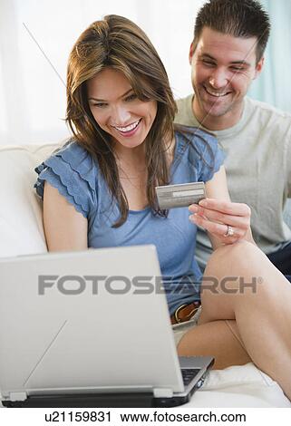 Smiling couple shopping online View Large Photo Image Stock Image - Smiling couple shopping online. Fotosearch