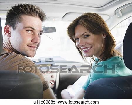 Smiling couple sitting in car View Large Photo Image Stock Photography - Smiling couple sitting in car. Fotosearch