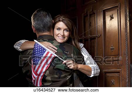 Stock Photo - Soldier with wife embracing. Fotosearch
