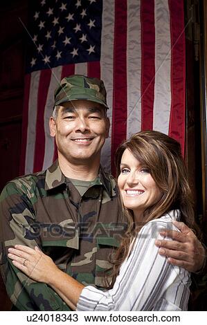 Soldier with wife embracing under american flag View Large Photo Image Stock Image - Soldier with wife embracing under american flag. Fotosearch