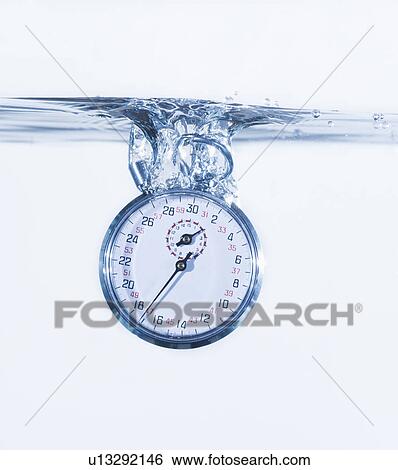 Stock Photograph - Stopper splashing into water, studio shot. Fotosearch