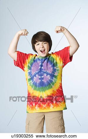 Stock Photography - Studio portrait of boy (10-11) flexing muscles. Fotosearch