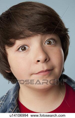 Picture - Studio portrait of boy (10-11) staring at camera. Fotosearch