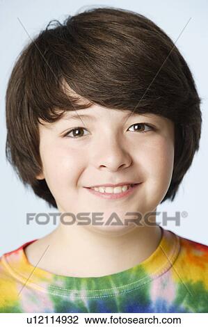 Stock Image - Studio portrait of boy (10-11). Fotosearch