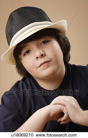 Studio portrait of boy (10-11) wearing hat View Large Photo Image Stock Image - Studio portrait of boy (10-11) wearing hat. Fotosearch