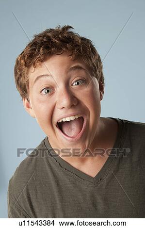 Picture - Studio portrait of boy (12-13) looking surprised. Fotosearch