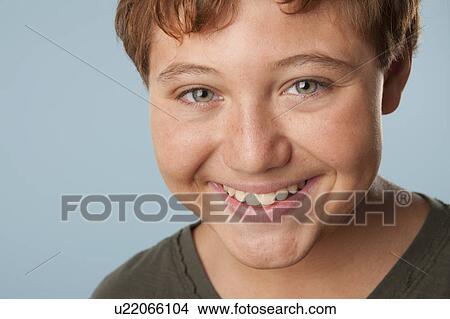 Picture - Studio portrait of boy (12-13) smiling. Fotosearch