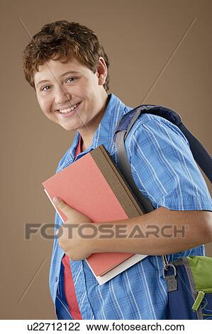 Studio portrait of boy (12-13) with backpack and books View Large Photo Image Stock Image - Studio portrait of boy (12-13) with backpack and books. Fotosearch