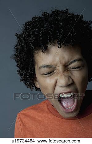 Picture - Studio portrait of boy (8-9) screaming. Fotosearch