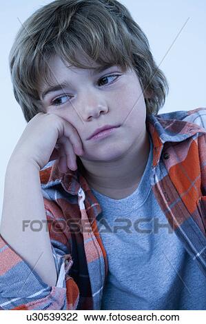 Stock Image - Studio portrait of boy (8-9). Fotosearch
