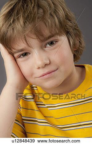 Stock Photo - Studio portrait of boy (8-9). Fotosearch