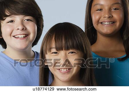 Studio portrait of boy and girls (10-11) View Large Photo Image Stock Photo - Studio portrait of boy and girls (10-11). Fotosearch
