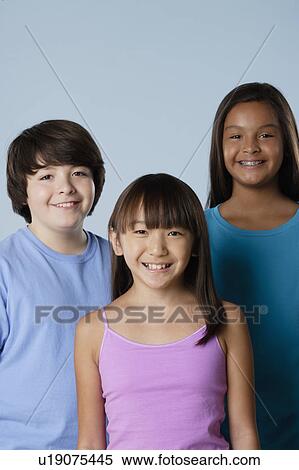 Stock Photography - Studio portrait of boy and girls (10-11). Fotosearch