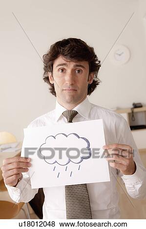 Studio portrait of businessman holding sheet of paper with cloud drawing View Large Photo Image Stock Photo - Studio portrait of businessman holding sheet of paper with cloud drawing. Fotosearch