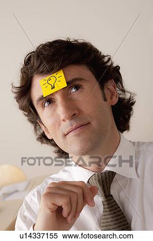 Studio portrait of businessman with adhesive note on forehead View Large Photo Image Stock Photography - Studio portrait of businessman with adhesive note on forehead. Fotosearch