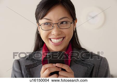 Picture - Studio portrait of businesswoman text-messaging. Fotosearch