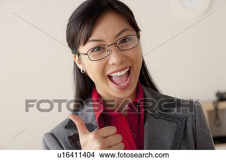 Studio portrait of businesswoman showing thumbs-up View Large Photo Image Picture - Studio portrait of businesswoman showing thumbs-up. Fotosearch