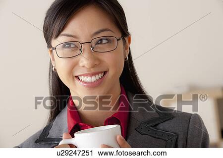 Studio portrait of businesswoman holding cup View Large Photo Image Stock Image - Studio portrait of businesswoman holding cup. Fotosearch