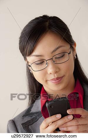 Studio portrait of businesswoman text-messaging View Large Photo Image Stock Photo - Studio portrait of businesswoman text-messaging. Fotosearch