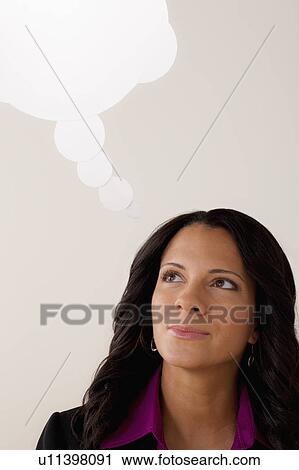 Stock Image - Studio portrait of businesswoman with thought bubble. Fotosearch