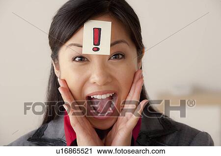 Studio portrait of businesswoman with exclamation mark sign on forehead View Large Photo Image Stock Image - Studio portrait of businesswoman with exclamation mark sign on forehead. Fotosearch